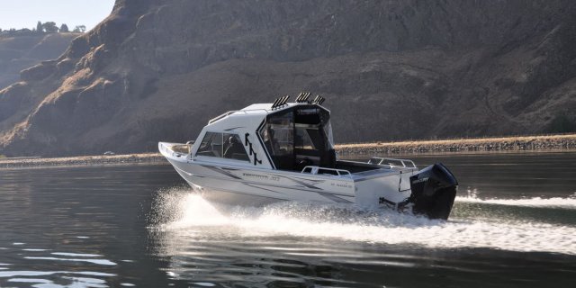 a thunderjet alexis crossover fishing and utility boat motoring across clear waters.