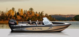 a Lund 1875 Crossover XS aluminum boat docked peacefully against an autumn sky.