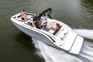 a happy family relax aboard a bayliner DX 2250 boat as they commute across a lake.