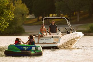 A couple and their daughters in a Bayliner VR5 in Muskoka near Toronto Ontario